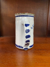 Load image into Gallery viewer, Pottery tankard handle with navy blue paint strokes. 
